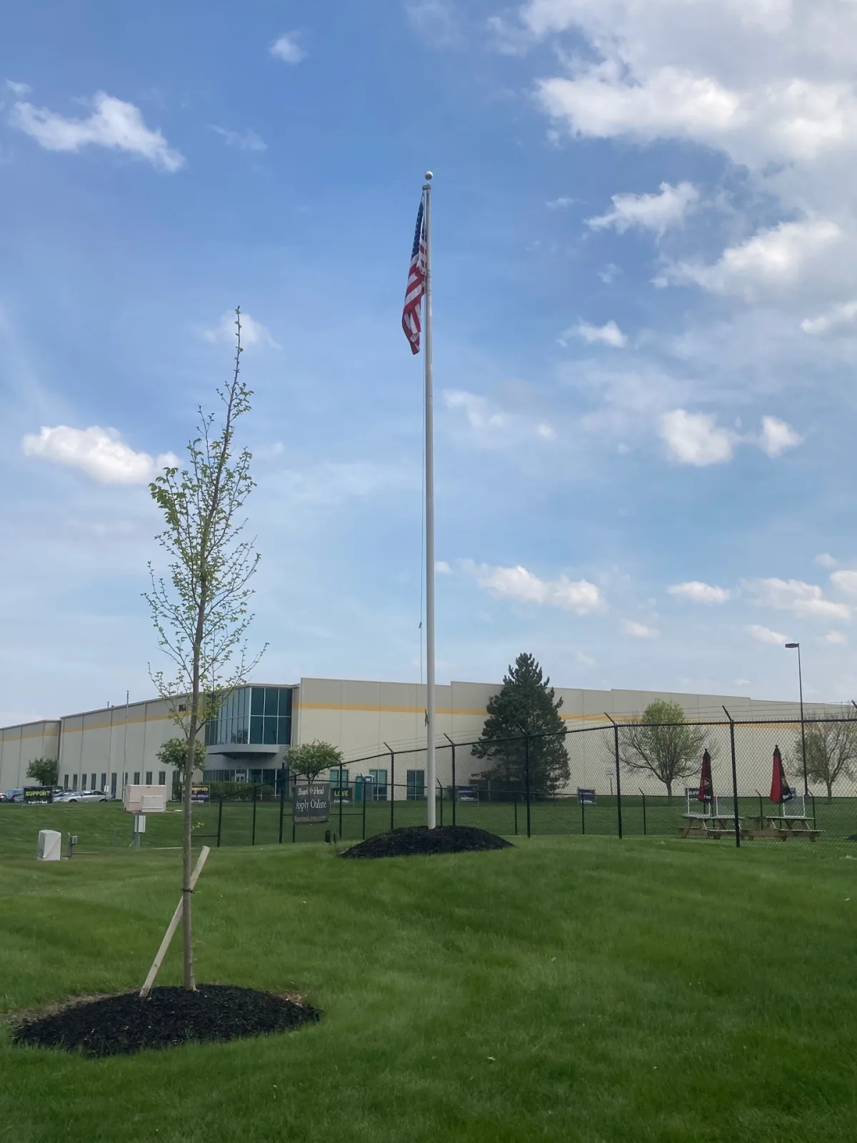 Tall commercial flagpole installed at Boar's Head distribution facility