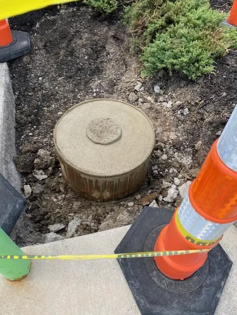 Commercial flagpole concrete footing with safety barriers